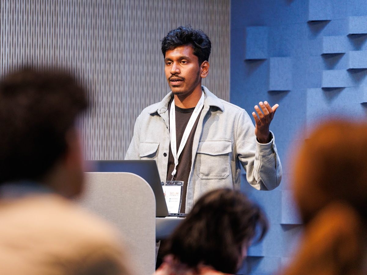 Samir Sengupta speaking on stage at the Apache Beam Summit 2026 in New York City, presenting real-time AI pipelines.